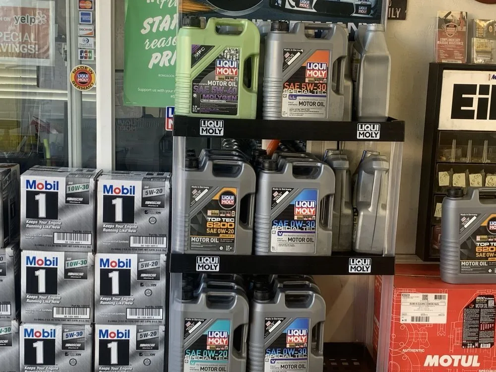 Shelves of Mobil 1, Liqui Moly and MOTUL motor oil in several viscosity grades inside Perfect Lube