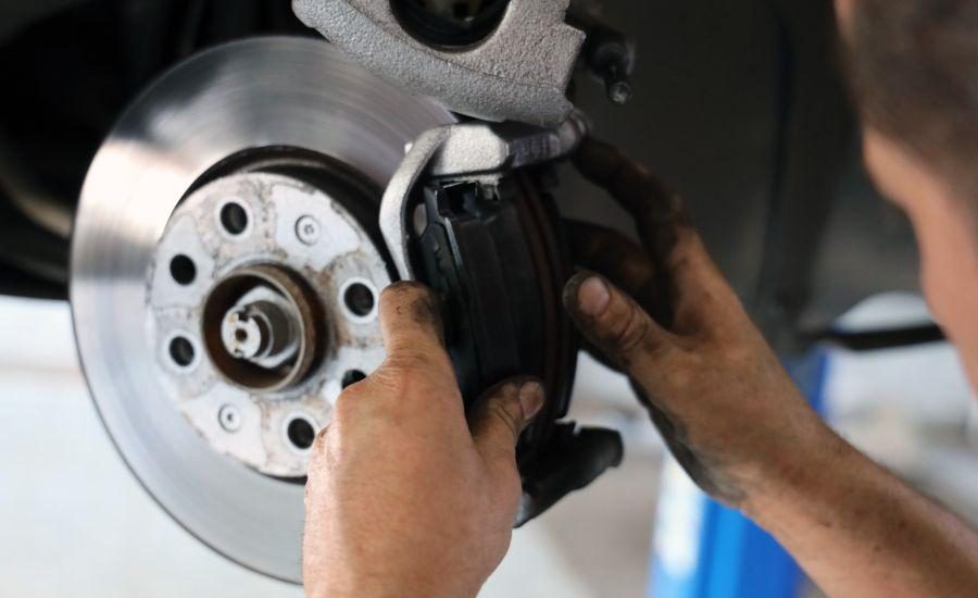 Brake rotor and caliper on a vehicle during a brake inspection