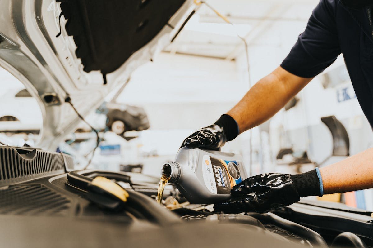 Motor oil being poured into an engine at Perfect Lube in San Carlos