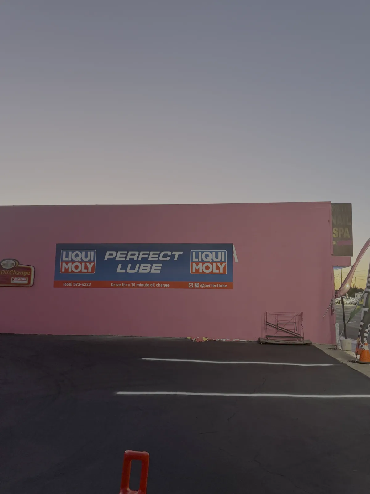 Perfect Lube's resurfaced and freshly striped parking lot in the evening